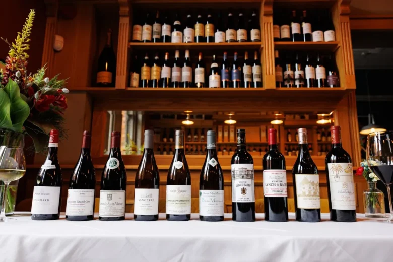 Selection of premium French wines displayed at La Maison Dublin with wine rack and floral arrangement in background.
