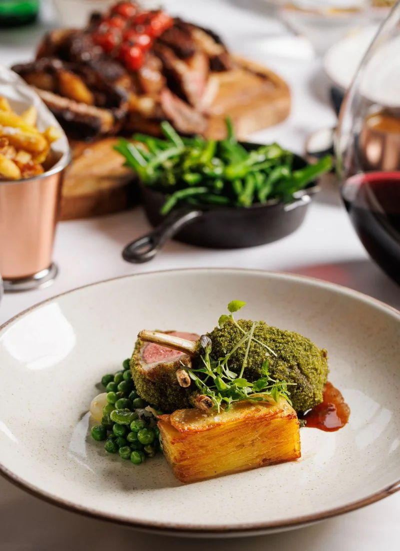 french-cuisine-dublin-mains-wine French-style main dish served with greens and a glass of red wine at La Maison Dublin