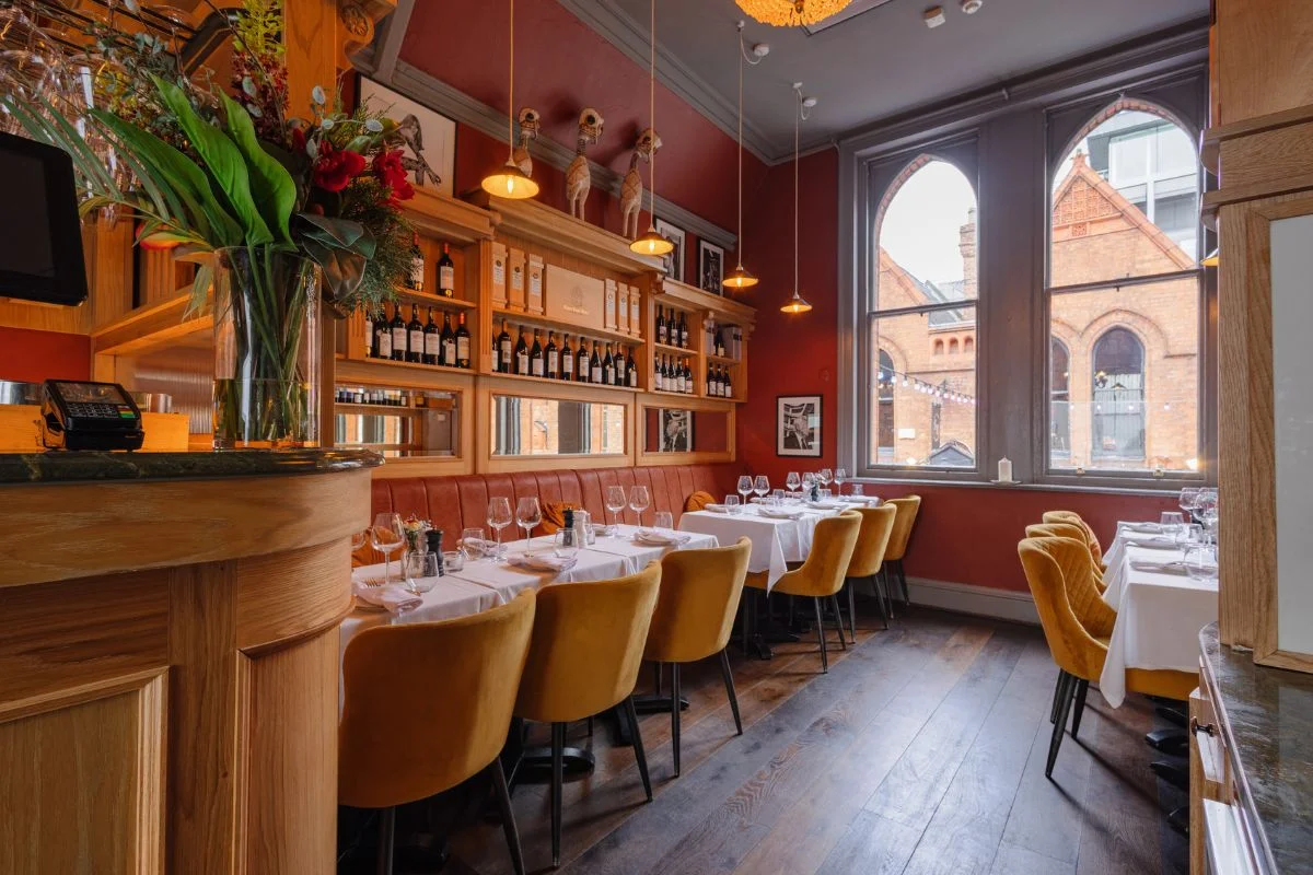 Elegant private dining room at La Maison in Dublin with wine display and ambient lighting
