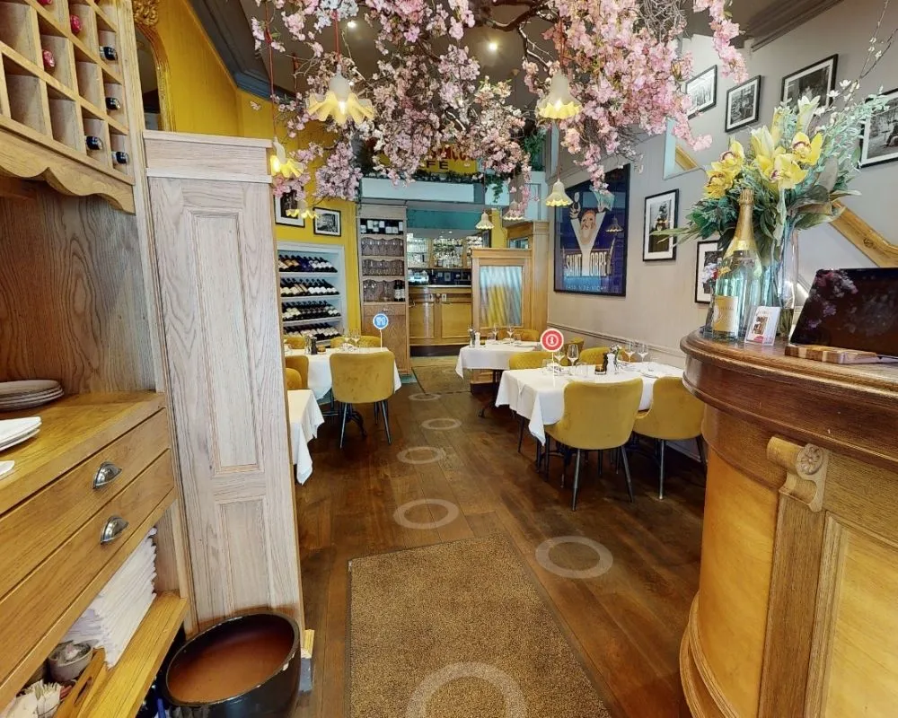 La Maison Dublin restaurant interior with elegant cherry blossom ceiling décor, white tablecloths, and warm wooden furnishings as seen in the virtual tour.